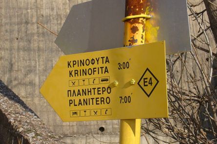 A yellow sign used for waymarking the E4 long distance path in Greece.