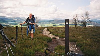 A walker taking a break on the Speyside way long distance path in Scotland. Original photo http://en.wikipedia.org/wiki/File:Cgg_tomintoul.jpg.