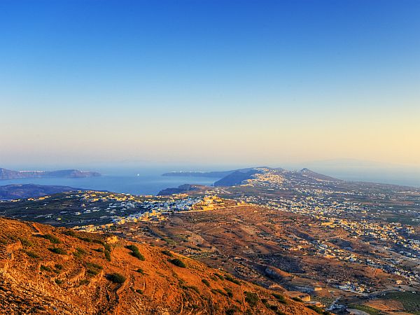 wide view on landscape of Santorini in golden early morning light