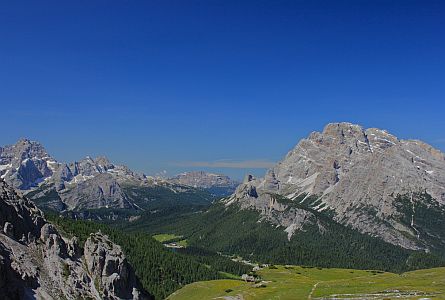 green meadows and rocky rounded peaks in the Dolomites