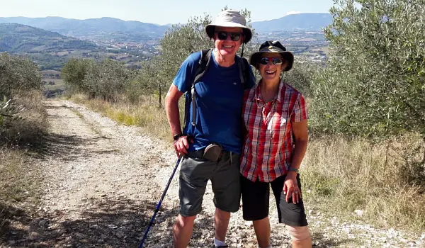 Couple hiking a path through an Italian landscape in Umbria