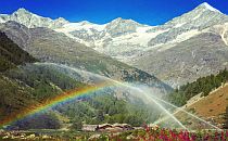 Mountain hut under a rainbow