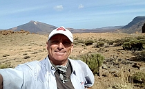 Man taking a selfie, dry valley in the background