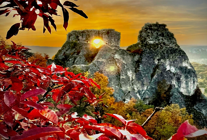 Rock formations in the distance, red leaves in the front