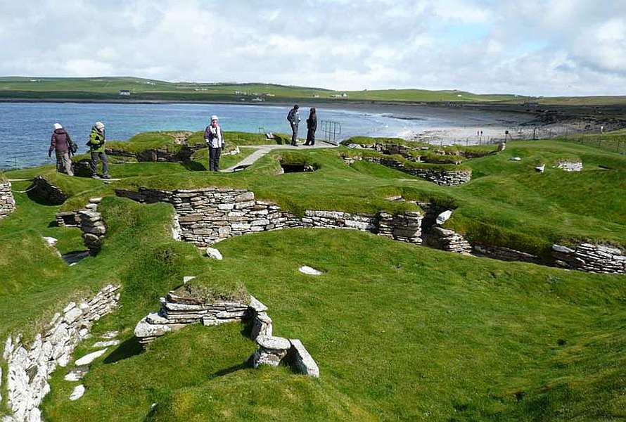 Hikers on a trail along ancient ruins