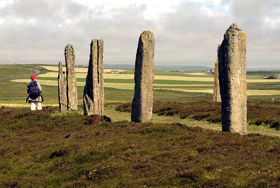 Hiker walking by huge standing stones