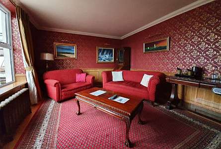 Cozy red room with sofas and a table