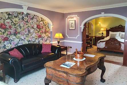 Cozy room with a sofa and a table, flower decorated wall