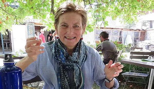 Female hiker taking a break with a glass of water
