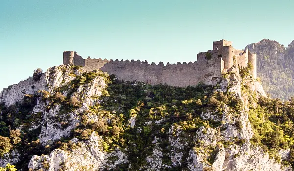 Ruins of a historic castle at the top of a steep cliff