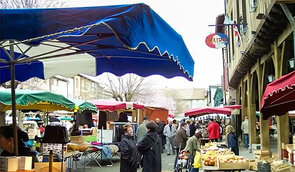 two women talking on a market in a French village